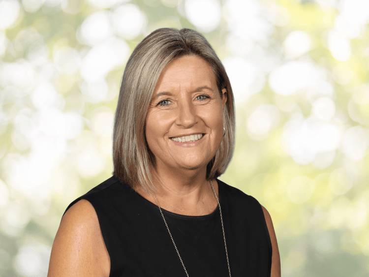 a person with blonde hair and a black top