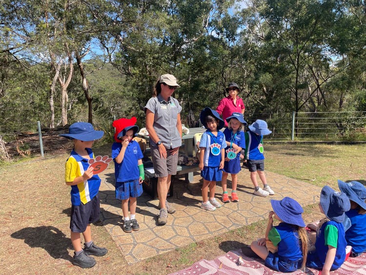 students standing with educator